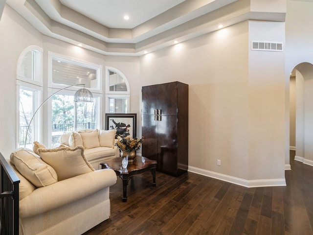 1885 Glen Oaks Dr, West Des Moines, IA 50266 - living room featuring arched walkways, baseboards, dark wood finished floors, a high ceiling, and recessed lighting