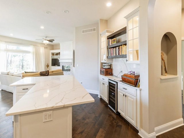 1885 Glen Oaks Dr, West Des Moines, IA 50266 - kitchen featuring beverage cooler, open floor plan, decorative backsplash, dark wood finished floors, and recessed lighting