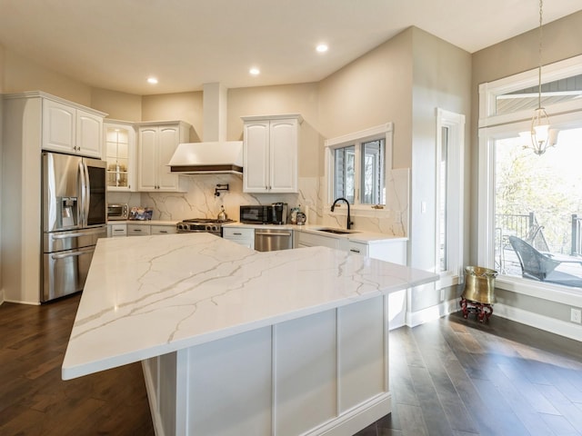 1885 Glen Oaks Dr, West Des Moines, IA 50266 - kitchen with stainless steel appliances, wall chimney exhaust hood, a kitchen island, dark wood-style flooring, and recessed lighting