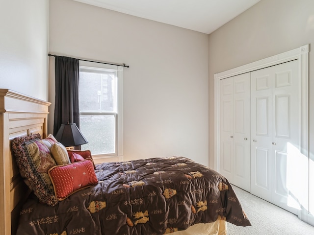 bedroom with a closet and light colored carpet