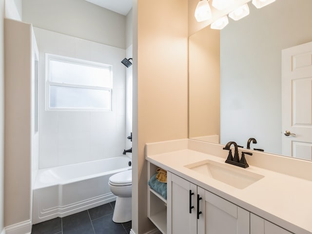 full bathroom with tile patterned floors, vanity, tiled shower / bath combo, and toilet