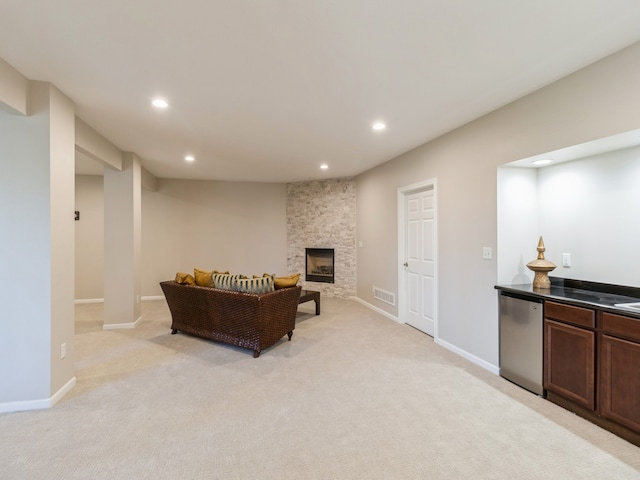 carpeted living room featuring a fireplace