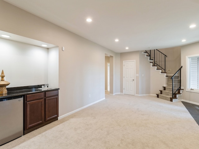 living room featuring light colored carpet and wet bar