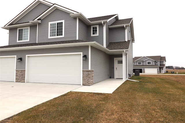 view of front facade featuring a garage, a front lawn, and cooling unit