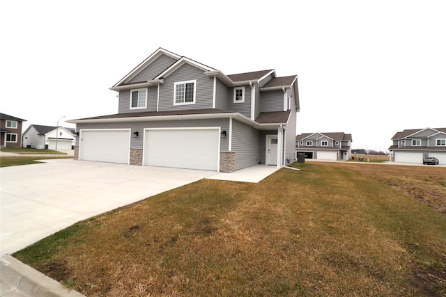 view of front of property with a front yard and a garage