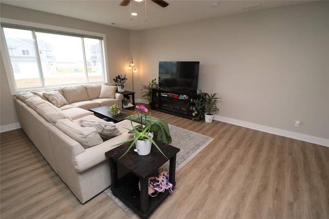 living room featuring hardwood / wood-style flooring and ceiling fan