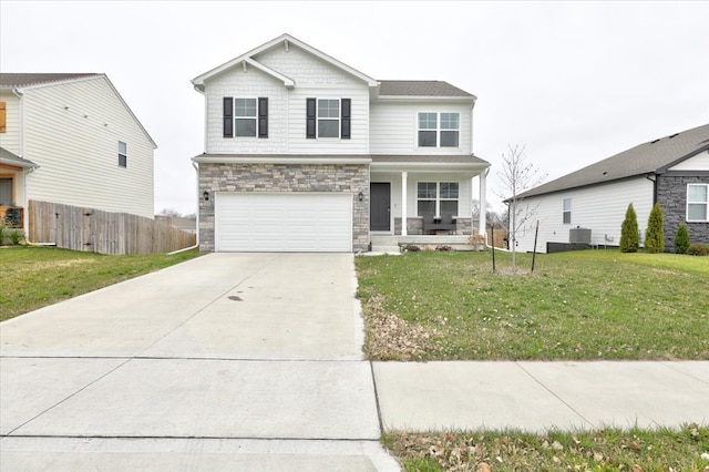 view of front of home featuring central air condition unit, covered porch, a front yard, and a garage