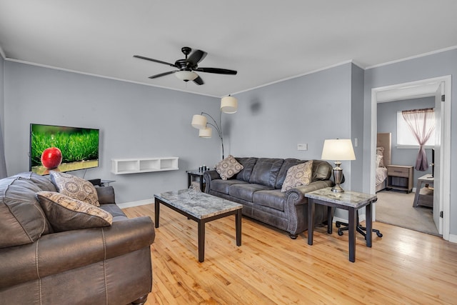 living room with light wood-type flooring, ceiling fan, and ornamental molding