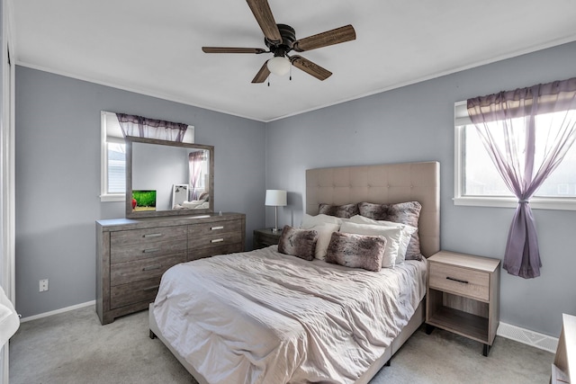 carpeted bedroom with ceiling fan and multiple windows