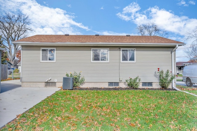 view of side of home featuring a lawn, central air condition unit, and a patio area