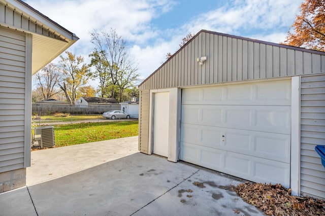 garage with central AC and a yard