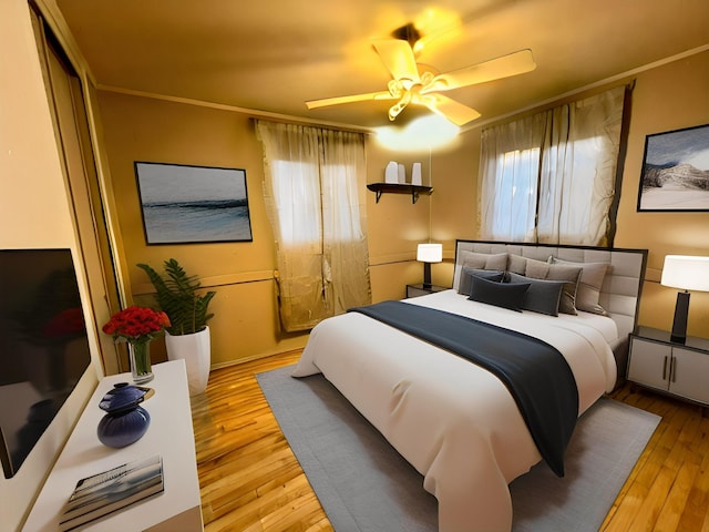 bedroom with ornamental molding, ceiling fan, and light wood-type flooring