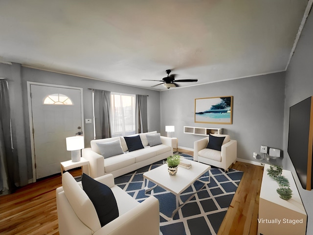 living room with wood-type flooring, crown molding, and ceiling fan