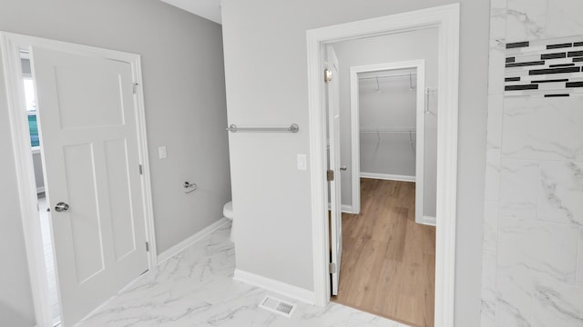 bathroom with marble finish floor, visible vents, and baseboards