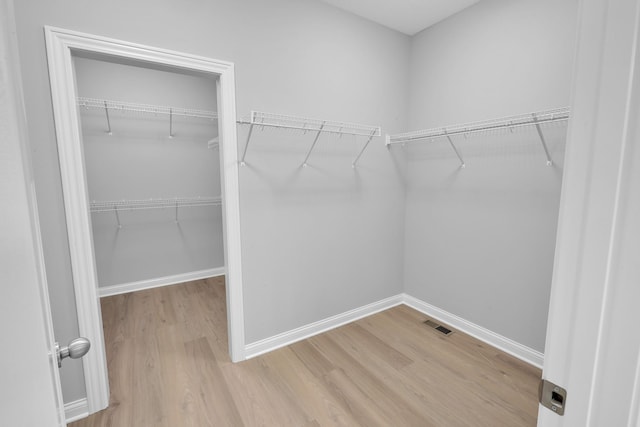 walk in closet featuring light wood-style flooring