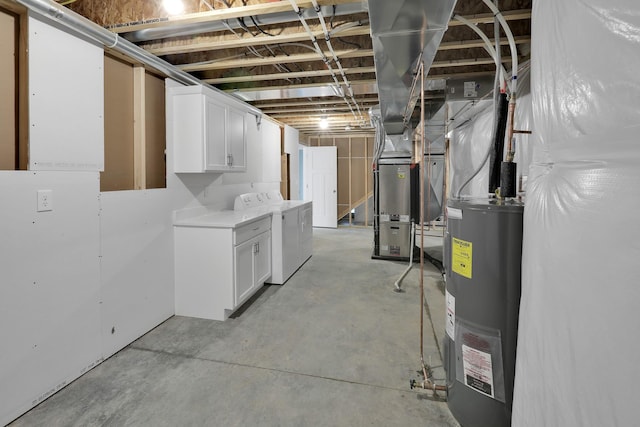 unfinished below grade area featuring water heater and washing machine and clothes dryer