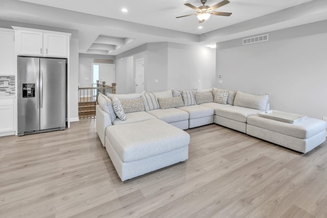 living room with baseboards, visible vents, a ceiling fan, light wood-style floors, and recessed lighting