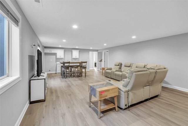 living area with recessed lighting, light wood-type flooring, and baseboards