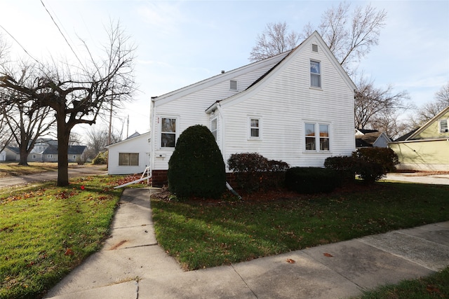 view of property exterior with a lawn