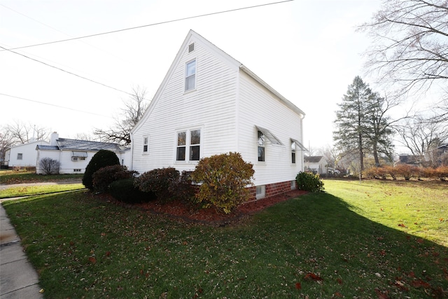 view of home's exterior with a yard