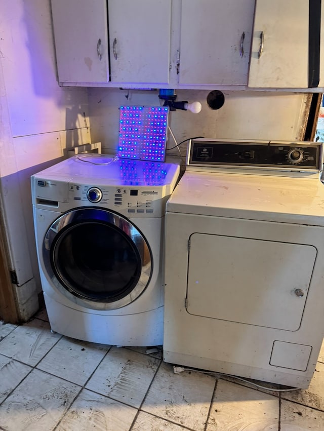 washroom featuring cabinets and separate washer and dryer