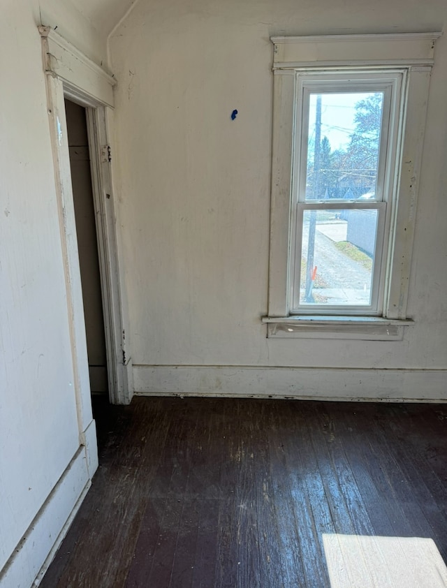 empty room with dark wood-type flooring