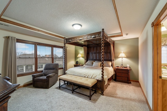 carpeted bedroom featuring ornamental molding, a textured ceiling, a tray ceiling, and multiple windows