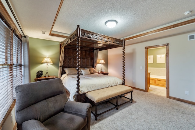 carpeted bedroom featuring a textured ceiling and connected bathroom