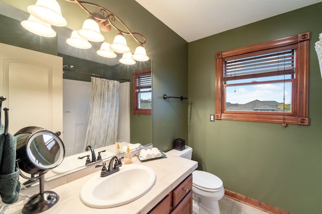 bathroom featuring tile patterned floors, vanity, toilet, and curtained shower