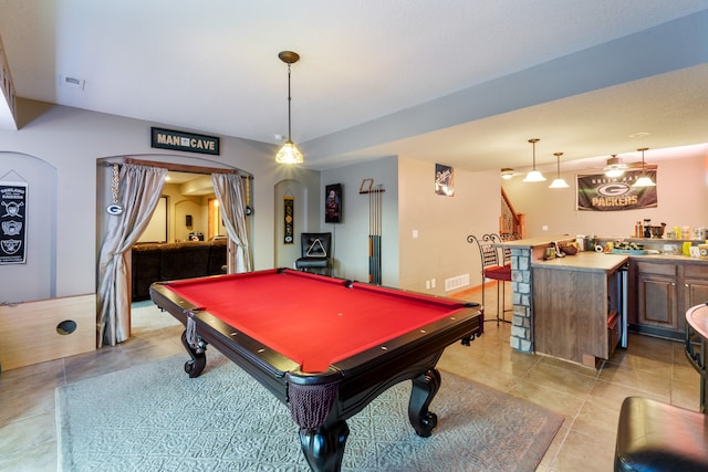 recreation room with bar area, light tile patterned floors, and billiards