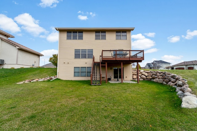 rear view of house featuring a deck and a lawn