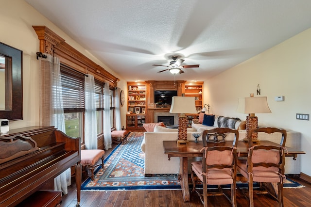 living room featuring a textured ceiling, dark hardwood / wood-style floors, and ceiling fan