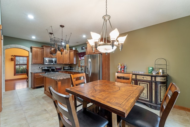 dining area with sink and a chandelier