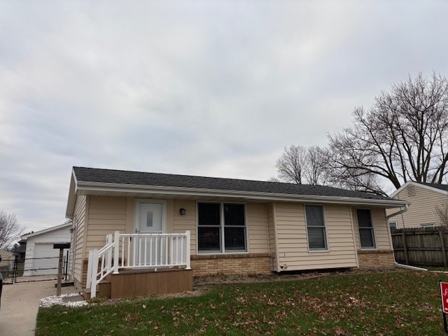 view of front of property with a garage, an outdoor structure, and a front yard