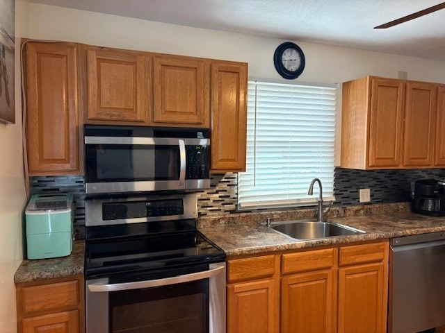 kitchen featuring tasteful backsplash, ceiling fan, sink, and stainless steel appliances