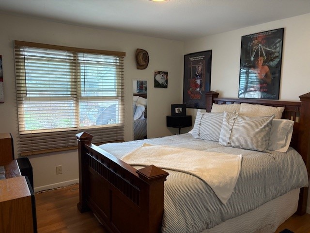 bedroom with hardwood / wood-style flooring