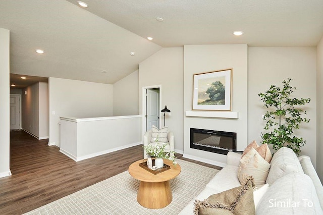 living room featuring lofted ceiling and dark hardwood / wood-style flooring