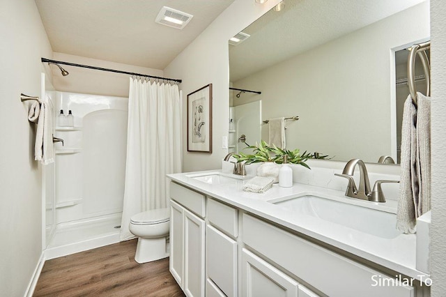 bathroom featuring vanity, toilet, hardwood / wood-style floors, and a shower with curtain