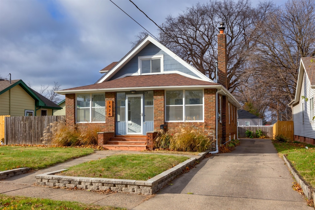 bungalow-style home with a front yard