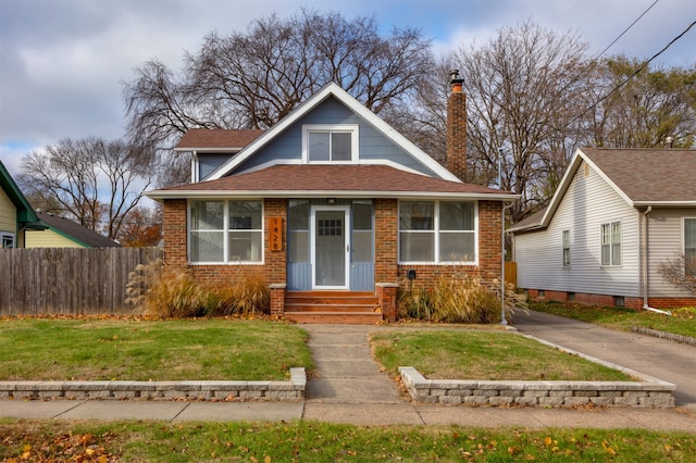 bungalow-style house with a front lawn