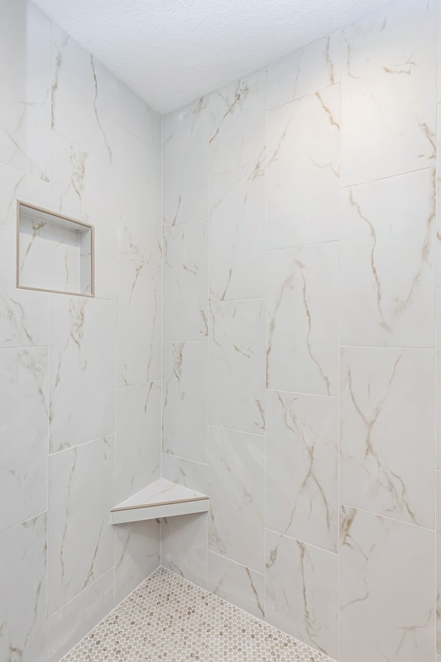 bathroom with a tile shower