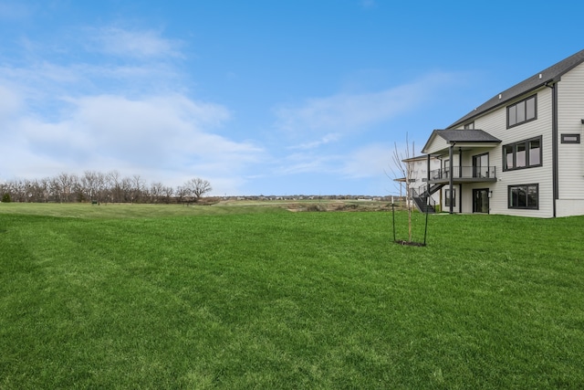 view of yard with a wooden deck and a rural view