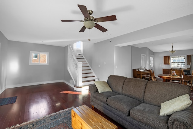 living room with ceiling fan and dark hardwood / wood-style flooring