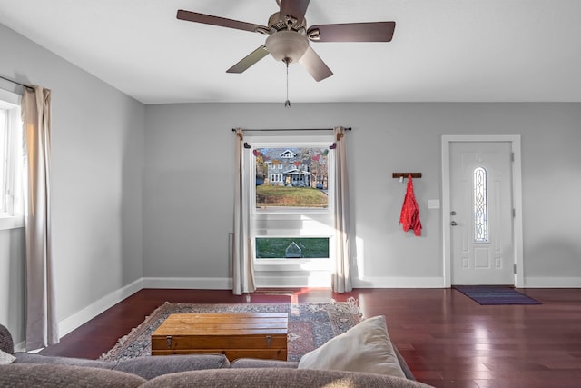 entryway with ceiling fan and dark wood-type flooring