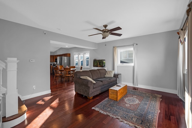 living room featuring ceiling fan and dark hardwood / wood-style flooring