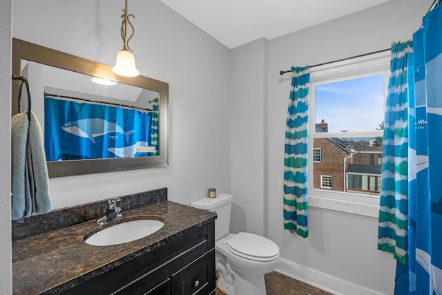 bathroom featuring vanity and toilet