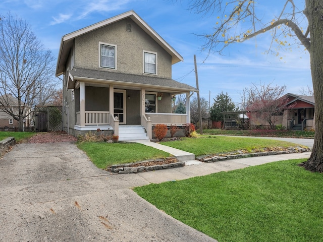 view of front of home with a porch and a front lawn