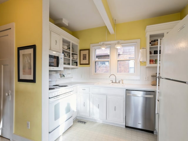 kitchen with beamed ceiling, white appliances, white cabinetry, and sink