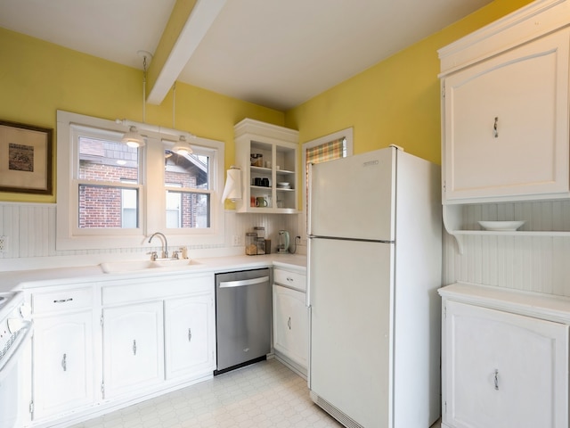 kitchen featuring white cabinets, beam ceiling, white appliances, and sink