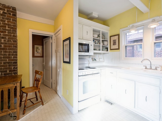 kitchen with white cabinets, white appliances, and sink